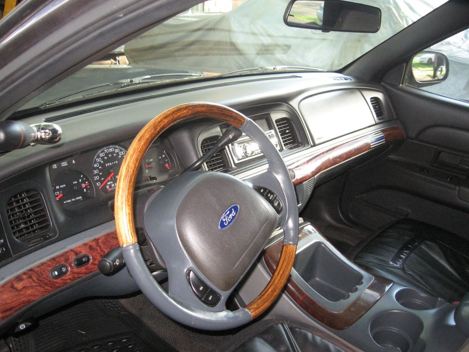 2003 Ford Crown Victoria interior with wood trim and Ford steering wheel