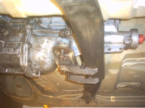 1991 Ford LTD Crown Victoria - Close-up of a vehicle's transmission and exhaust system from below.