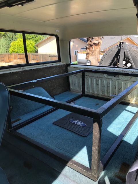 1981 Ford Bronco - The interior of the vehicle features a custom metal cage and a spare tire mounted on the rear.