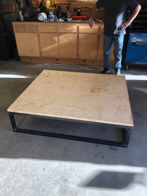 1981 Ford Bronco - A wooden platform sits on a metal frame in a workshop environment.