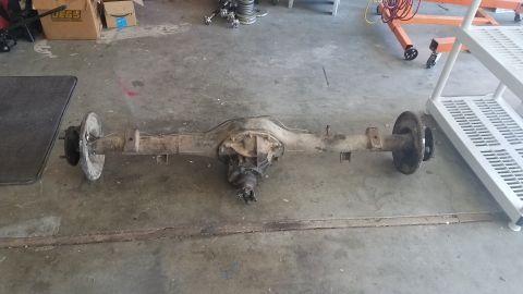 1985 Ford Bronco - Rear axle assembly removed from a vehicle, showing the differential and brake components.