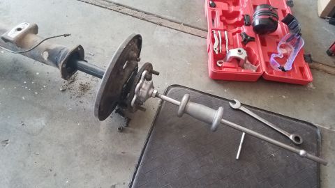 1985 Ford Bronco - A disassembled rear axle assembly is shown with a slide hammer attached, suggesting repair or maintenance work.