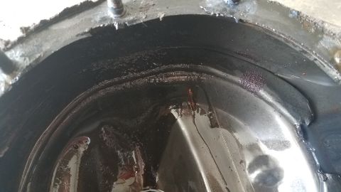 1985 Ford Bronco - Close-up view of the inside of a differential housing, showing wear and debris.