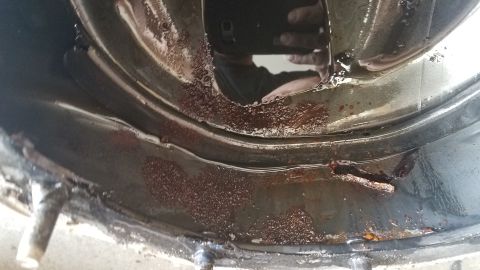 1985 Ford Bronco - This image shows a corroded metal part, likely from a vehicle's drivetrain, with visible rust and grime.