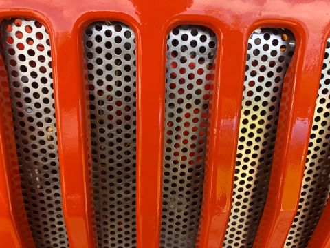 1992 Jeep Wrangler - A detailed view of the iconic Jeep grille, its distinctive vertical slots and perforated metal mesh.