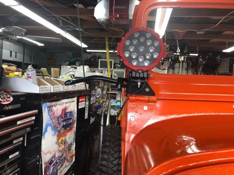 1992 Jeep Wrangler - An orange Jeep Wrangler is partially visible from the side, fitted with a large LED light and a website logo.