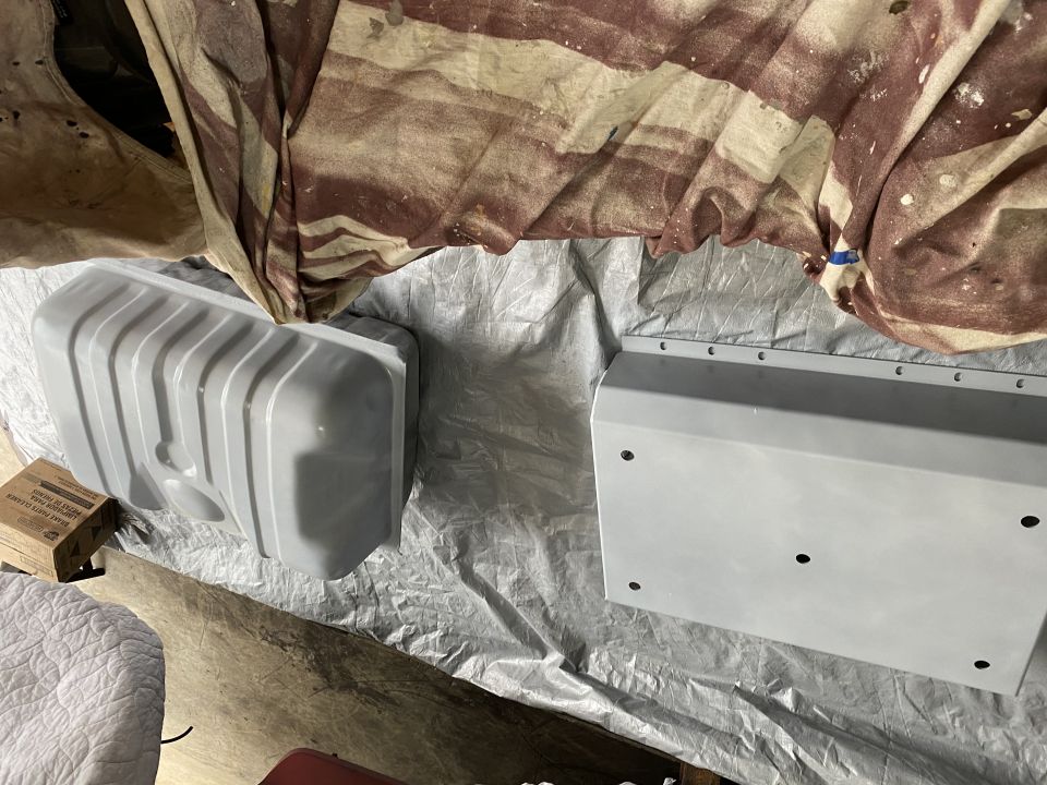Vehicle fuel tank and skid plate on a tarp