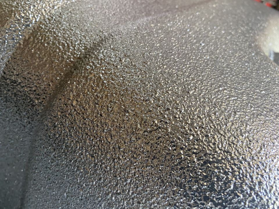 Silver textured metal part with a granular surface