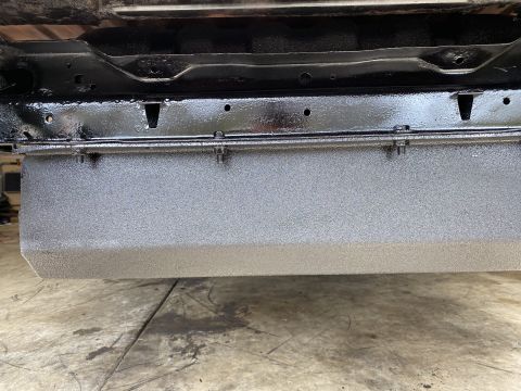 1994 Ford Bronco - Underbody view of a vehicle, a textured gray panel and black frame. Supermotors.net logo is present.