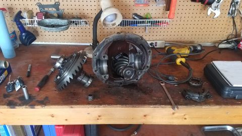 1985 Ford Bronco - Differential components are laid out on a workbench, suggesting a repair or rebuild process.
