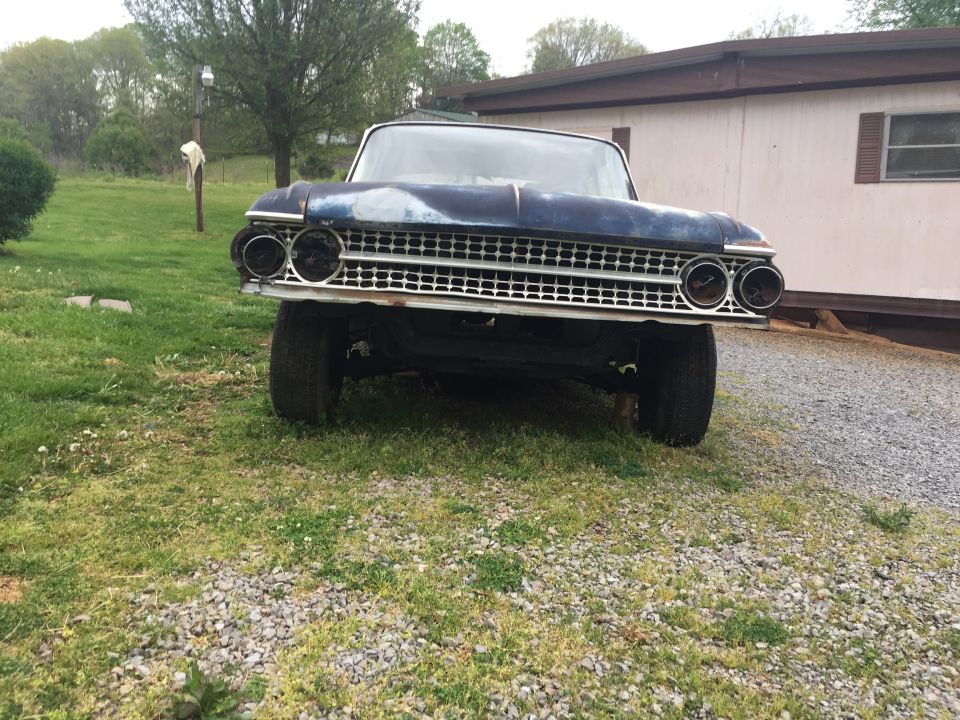 1961 Ford Galaxie front view, blue paint, grille with dual headlights, parked on grass