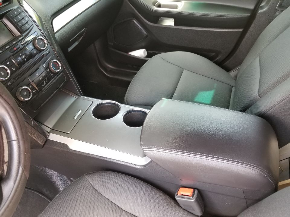 Interior center console with cup holders and armrest