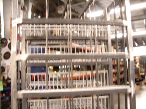 1973 Ford Ranchero - A metal shelving unit is filled with various items, suggesting a storage or parts facility.