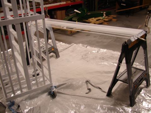 1973 Ford Ranchero - White painted metal structure and pipes are set up on plastic sheeting, possibly for a project.