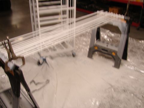 1973 Ford Ranchero - White pipes are arranged on a tarp, supported by a folding sawhorse and a rolling cart.