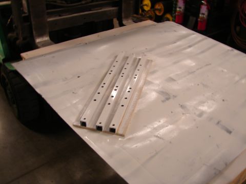 1973 Ford Ranchero - Metal strips are laid out on a white surface, with a forklift visible in the background.