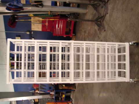 1973 Ford Ranchero - White metal shelving unit with multiple compartments and wheels, likely for storage.