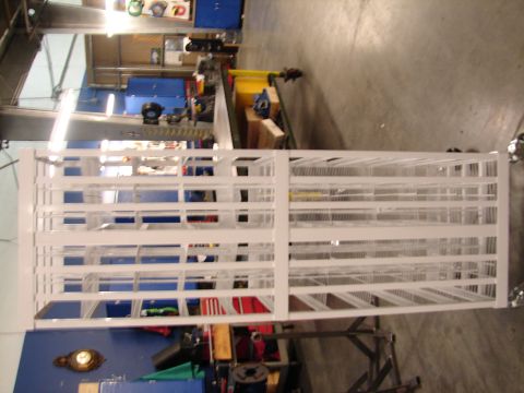 1973 Ford Ranchero - A white metal shelving unit is shown in a workshop setting with various tools and storage cabinets visible.