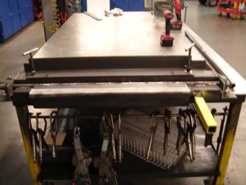 1973 Ford Ranchero - A metal fabrication table is shown with various clamps and a cordless drill on its surface.