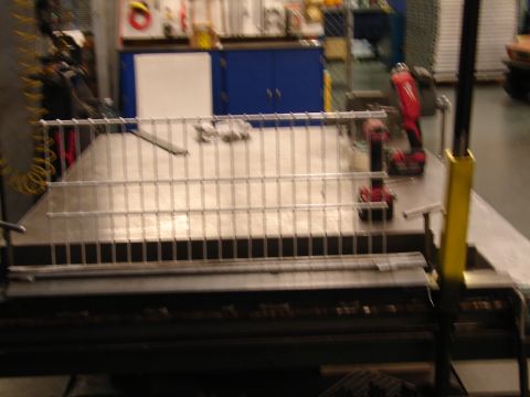1973 Ford Ranchero - A metal grating is laid out on a workbench with two cordless drills nearby in a workshop setting.