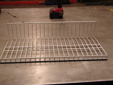 1973 Ford Ranchero - A white wire rack is shown on a workbench, with tools visible in the background.