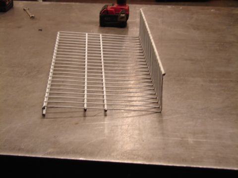 1973 Ford Ranchero - Wire rack on a workbench, possibly for storage or a project.