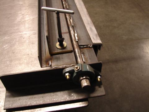 1973 Ford Ranchero - This image shows a close-up of a metal component with a t-handle and a bearing assembly, likely part of a larger machine.