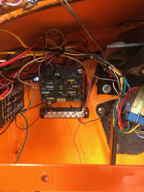 1992 Jeep Wrangler - A close-up view of a vehicle's fuse box and wiring harness, predominantly orange in color, with various wires and connectors visible.