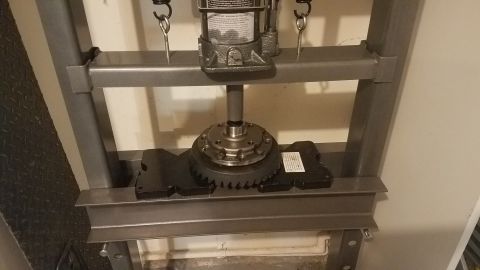 1985 Ford Bronco - A differential gear assembly is being pressed into place on a hydraulic press. The assembly includes a large ring gear and a smaller differ…