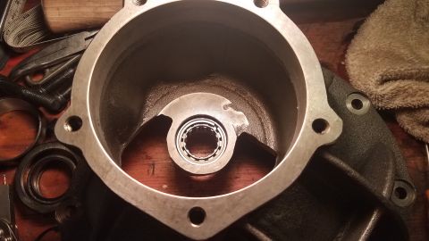 1985 Ford Bronco - A close-up view shows a disassembled automotive part, likely a transmission or differential housing, with a bearing visible inside. Various…