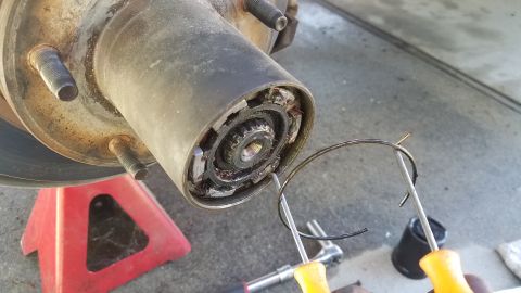 1985 Ford Bronco - The differential assembly is shown from below, supported by jack stands.