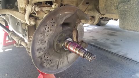 1985 Ford Bronco - This image shows the front wheel hub assembly of a vehicle, likely undergoing maintenance or repair.