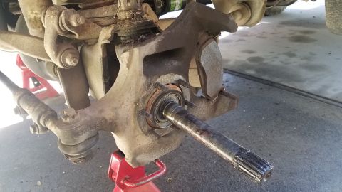 1985 Ford Bronco - Close-up view of a vehicle's front suspension and braking system components.