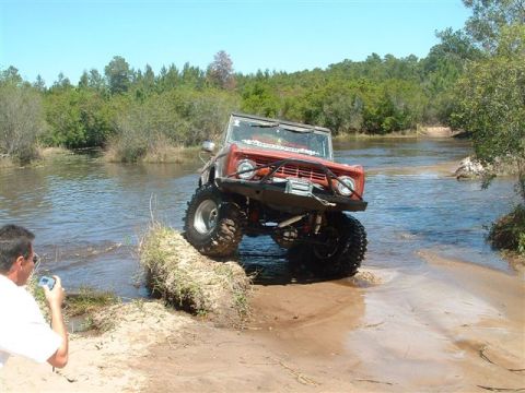 1986 Ford Bronco - This lifted Ford Bronco navigates a shallow water crossing on a sunny day.