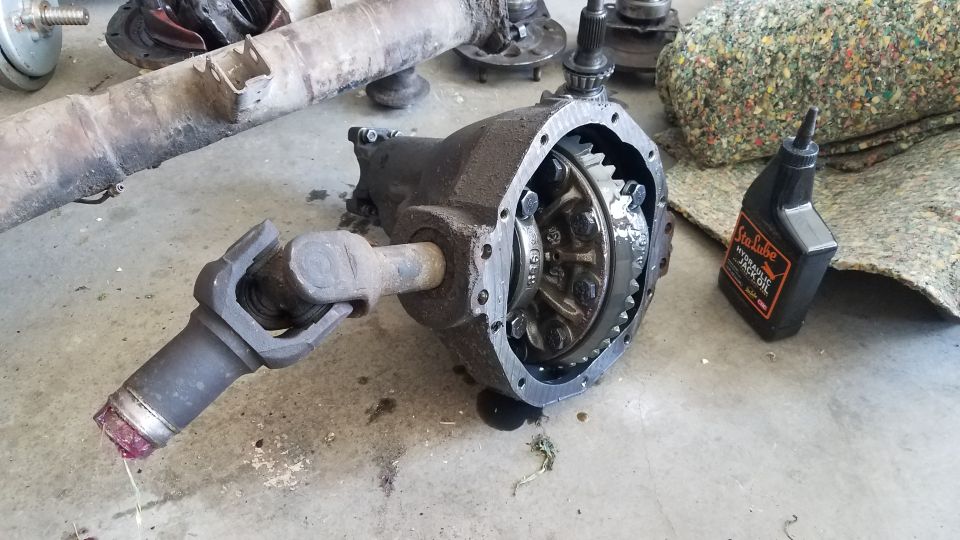 Differential housing with driveshaft and bottle of Sta-Lube hydraulic jack oil.