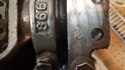 1985 Ford Bronco - Close-up view of engine components, showing stamped numbers '366' on one part and an arrow marking on two separate parts. The parts appear…