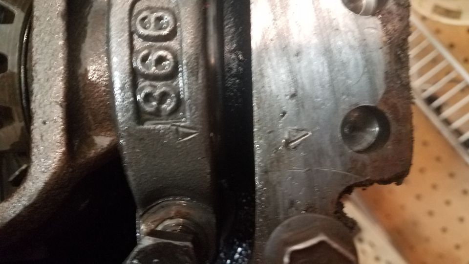 Stamped numbers '366' and arrows on metal engine parts