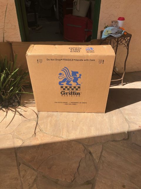 1992 Jeep Wrangler - A large cardboard box with the Griffin Radiator logo is shown outdoors on a stone patio. The box has shipping instructions and company info…