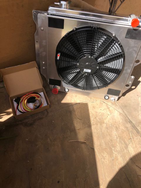 1992 Jeep Wrangler - A new aluminum radiator with an electric fan is shown next to a small cardboard box containing wiring and a temperature sensor. The radiato…
