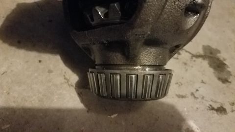 1985 Ford Bronco - A close-up shot shows a differential housing with a roller bearing pressed onto its base. The housing appears to be made of cast iron and i…