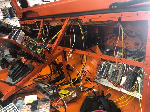 1992 Jeep Wrangler - The interior of an orange Jeep Wrangler is shown with a complex wiring harness and multiple fuse blocks installed. Various electrical compo…