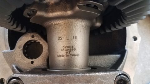1985 Ford Bronco - A close-up view of a differential assembly shows stamped markings including '22 L 18', '52825', '913A586', 'HT', and 'Made in Taiwan'.
