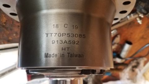 1985 Ford Bronco - A close-up shot shows engraved text on a metal automotive part, including a date code '18 C 19', a part number 'TT70P53085', and 'Made in T…