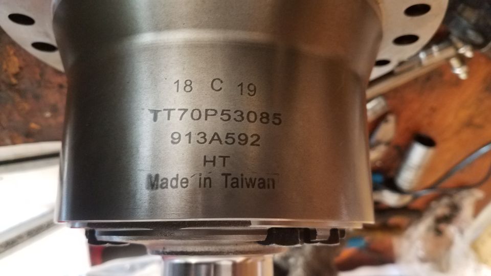 Engraved text on a metal automotive part: 18 C 19, TT70P53085, 913A592, HT, Made in Taiwan.