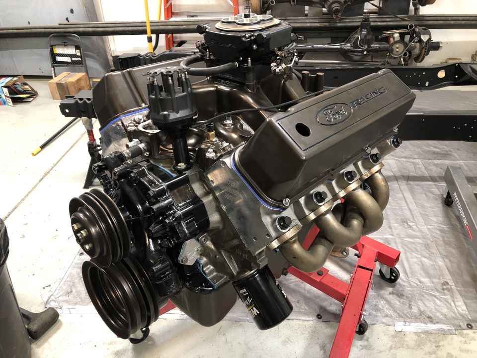 Engine assembly with black components and some red parts visible