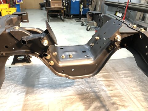 1979 Ford Bronco - This photo shows the frame and suspension components of a vehicle, likely in a workshop setting.