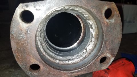 1985 Ford Bronco - Rusty exhaust pipe flange with visible wear and tear on the inner diameter.