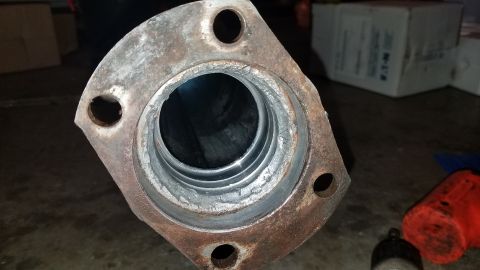 1985 Ford Bronco - This is a close-up view of a used exhaust flange, showing signs of rust and wear around the pipe opening.