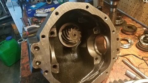 1985 Ford Bronco - Close-up of a differential housing, showing internal gears and bearings laid out on a workbench.