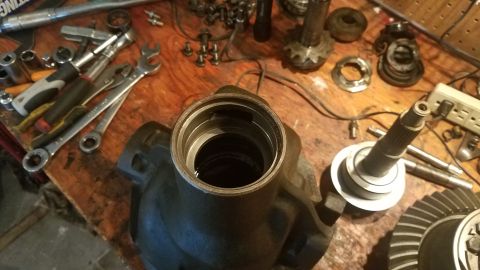1985 Ford Bronco - Tools and parts for a differential rebuild are laid out on a wooden surface.
